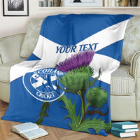 Close view of blue and white Scotland cricket blanket with thistle graphic and 'YOUR TEXT'