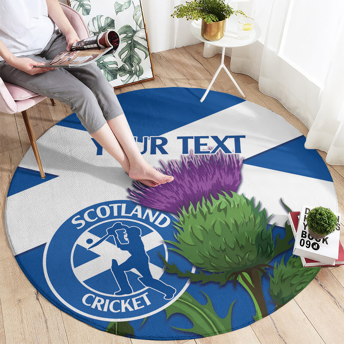 Round blue-and-white Scotland cricket rug with thistle graphic and custom text strip