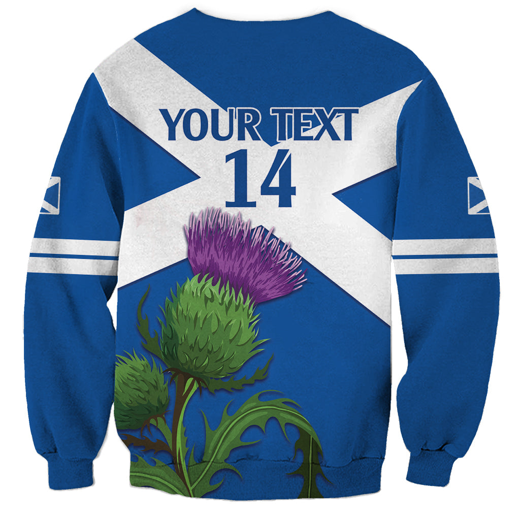 Blue crewneck sweatshirt with white diagonal flag, YOUR TEXT 14 back print, thistle