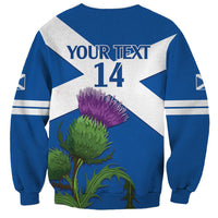 Blue crewneck sweatshirt with white diagonal flag, YOUR TEXT 14 back print, thistle