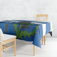 Blue tablecloth with green thistle-style floral graphic, draped over table corner