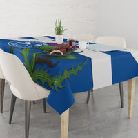 Blue tablecloth with green floral pattern and hanging corner, on dining table