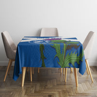 Blue tablecloth with green floral design and thin white stripe on dining table