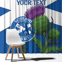 Close-up blue and white curtains with Scotland Cricket emblem and purple thistle