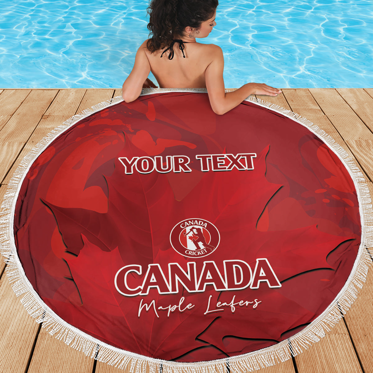 Red round beach blanket with white fringe showing 'YOUR TEXT' and Canada Cricket print