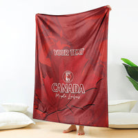 Red Canada cricket blanket draped on floor with YOUR TEXT and maple leaf design