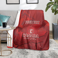 Red Canada cricket blanket over armchair, YOUR TEXT center with maple leaf graphic