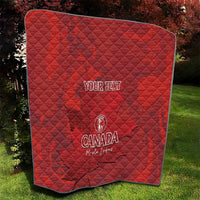 Red quilt blanket with custom text and Canada emblem, close-up on diamond quilting