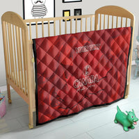 Red quilt blanket with custom text and Canada logo on crib, quilted diamond pattern