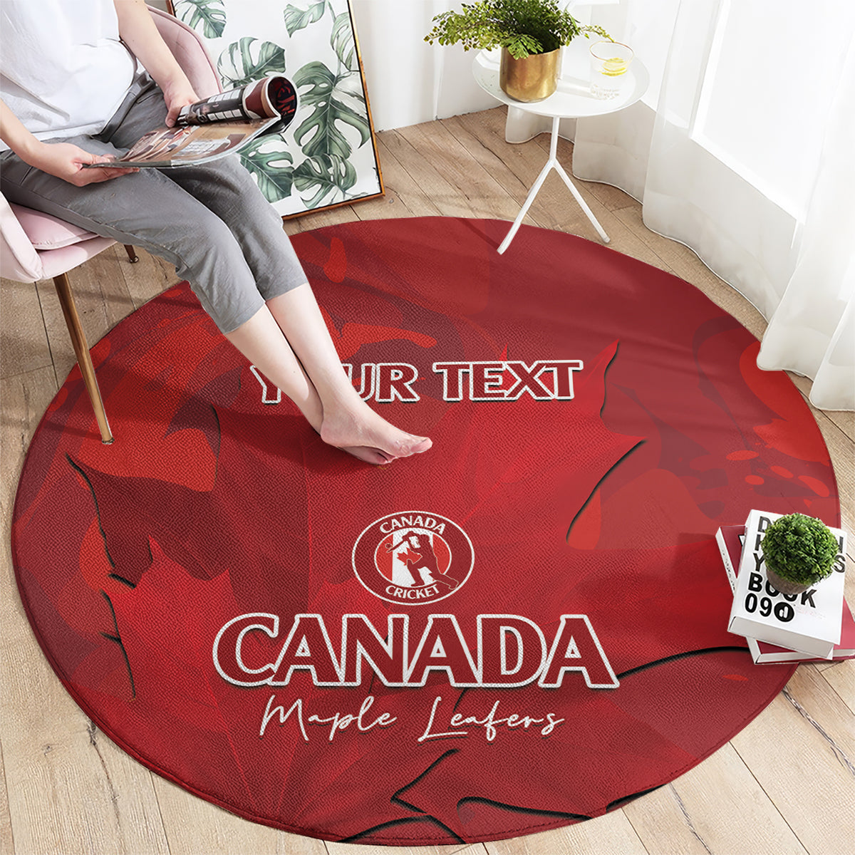 Red round carpet with Canada cricket logo, maple leaves, and 'YOUR TEXT' print.