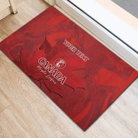 Red rubber doormat with 'YOUR TEXT' and Canada Maple Leaf logo, corner view
