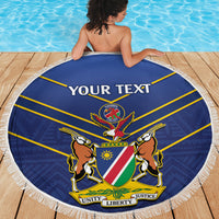 Blue round beach blanket with white fringe, Namibia Cricket shield crest and “YOUR TEXT”