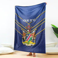 Blue cricket blanket draped with yellow stripes, 'YOUR TEXT' and national crest.