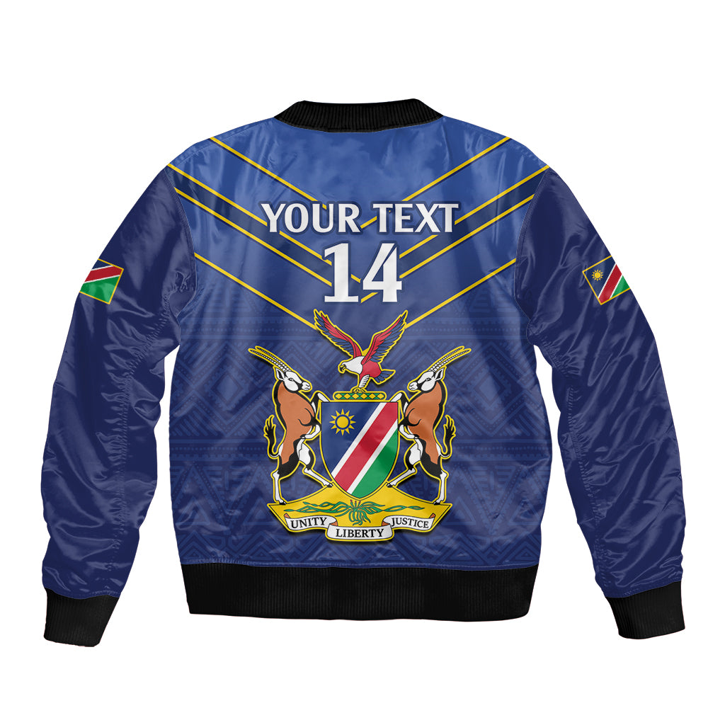 Blue cricket bomber jacket, back graphic with YOUR TEXT 14, eagle emblem, gold diagonal lines