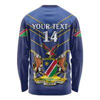 Blue long sleeve cricket shirt with back graphic, crest, and '14' text