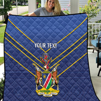 Blue quilt with diamond quilting, yellow diagonal stripes, crest emblem and “YOUR TEXT”