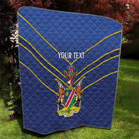 Blue quilt with yellow diagonal stripes and crest emblem, “YOUR TEXT” centered