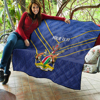 Blue quilt with yellow diagonal stripes and crest emblem, “YOUR TEXT” on sofa