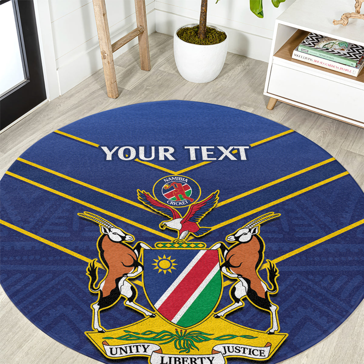 Blue round cricket rug with Namibia crest and lions, yellow border and “YOUR TEXT”.