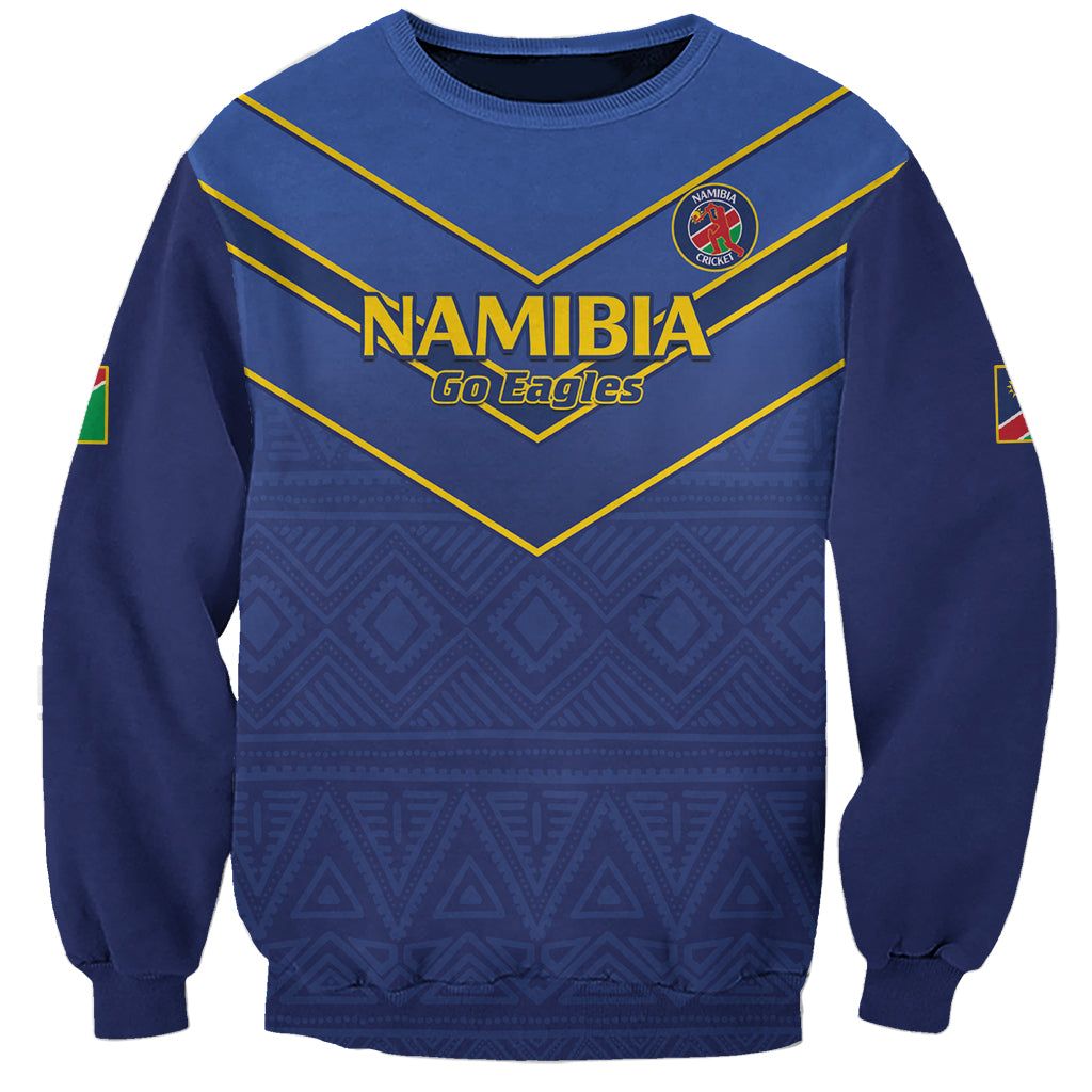 Blue crewneck cricket sweatshirt with Namibia Go Eagles graphic and patterned hem