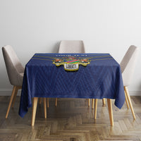 Blue tablecloth with yellow stripes and crest badge on small table