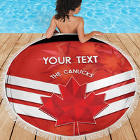 Round beach blanket laid on wooden deck, red-white Canadian flag with maple leaf and fringe