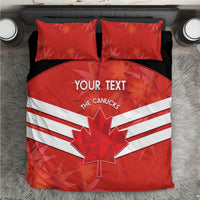 Red bedding set viewed from above, duvet with maple leaf and white stripes, two red pillows