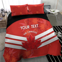 Red bedding set with duvet featuring maple leaf and white stripes, two red pillows on dark base