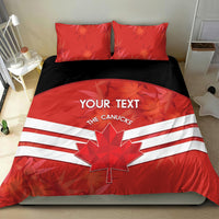 Red bedding set with duvet showing maple leaf and white stripes, plus two matching pillows