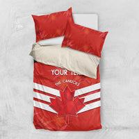 Red duvet and pillow bedding set with maple leaf graphic and white striped band