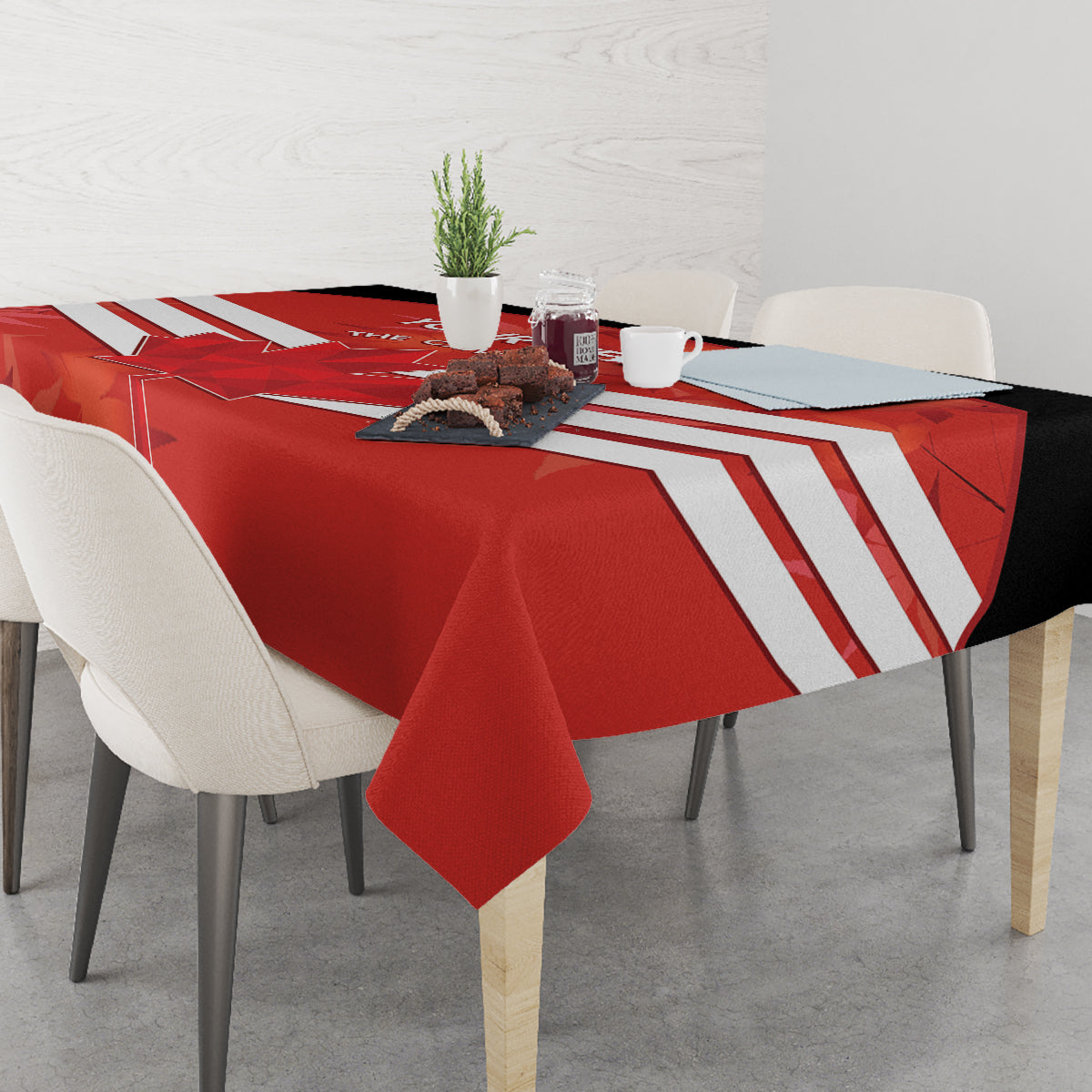Red tablecloth covering dining table with white stripe pattern and folded corners.