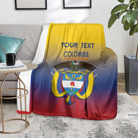 Football blanket on a rug with Colombia crest and 'YOUR TEXT' on yellow-blue-red fade.