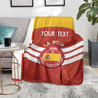Spain football blanket draped over furniture, red with white stripes, crest, and 'YOUR TEXT'.