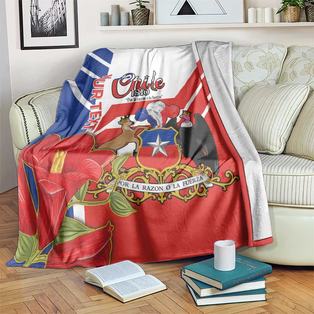 Chile-themed blanket on bed with coat of arms, red base, blue-white stripes and flower