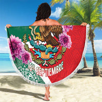 Round beach blanket with green-and-red eagle crest, pink flowers, and white fringe