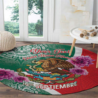 Round decorative carpet with green-and-red Aztec design, eagle motif, and pink flowers