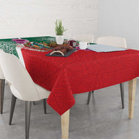 Red patterned tablecloth with green Aztec panel, draped to the table edges