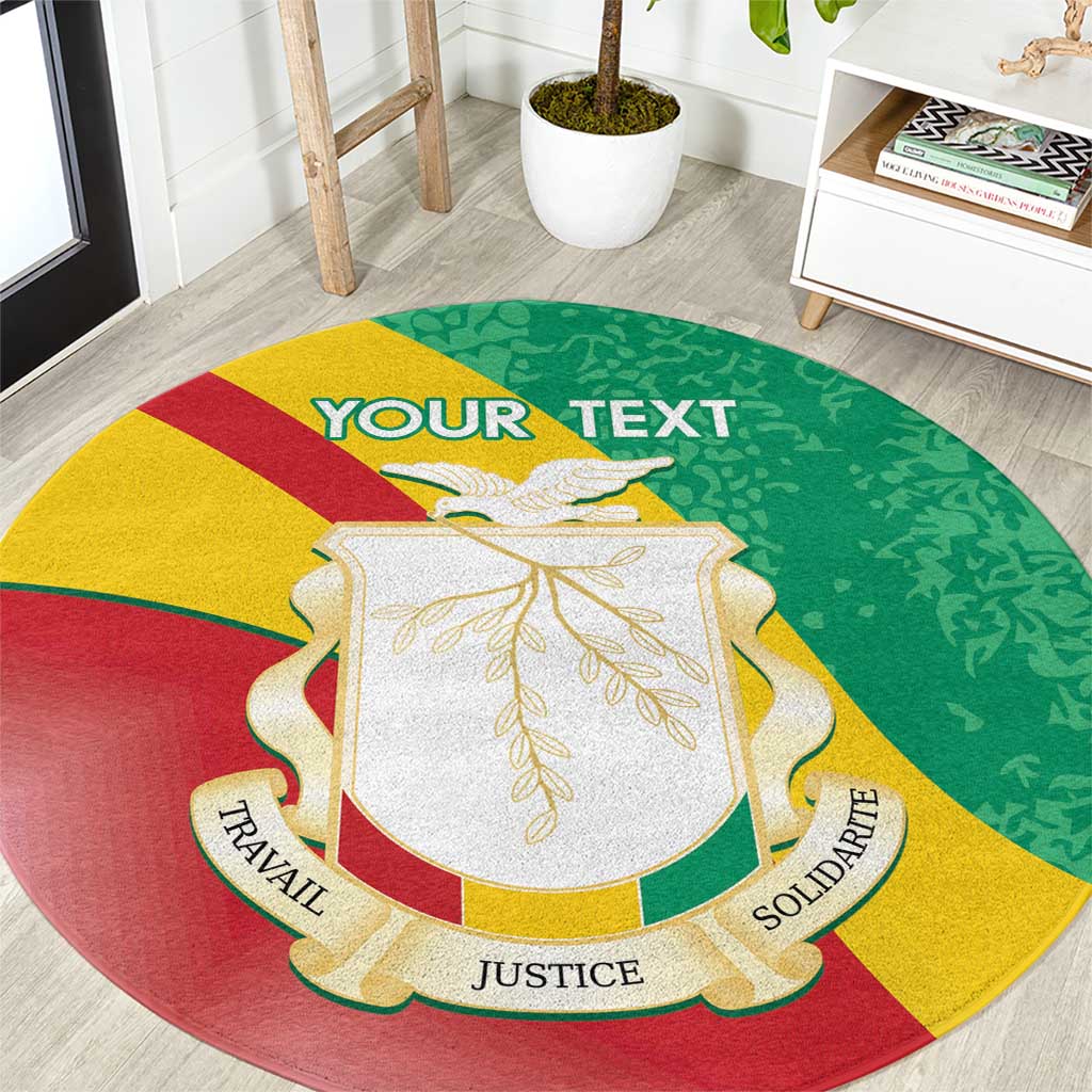 Round green carpet with Guinea coat of arms and gold laurel, “YOUR TEXT” at top