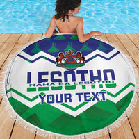 Round beach blanket with 'YOUR TEXT' and Lesotho crest, blue and green zigzag chevrons