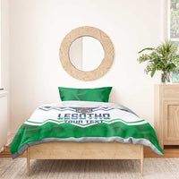 Personalized Lesotho bedding set with green-and-blue crest zigzag duvet on wooden bed