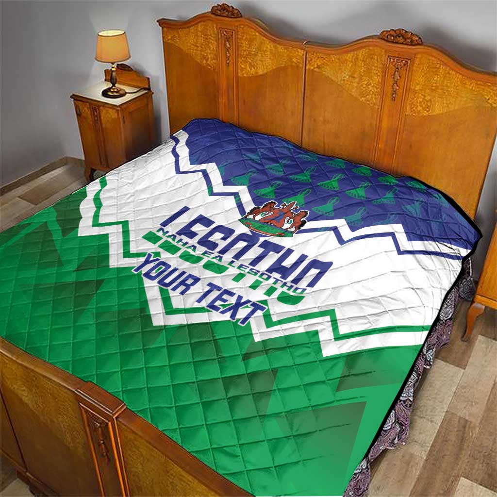 Personalised quilt covering a bed: blue top, white center, green bottom with crest