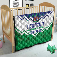Personalised quilt on a toddler bed with blue, white, and green chevron stripes