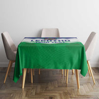 Green personalised tablecloth draped over small dining table with printed top band