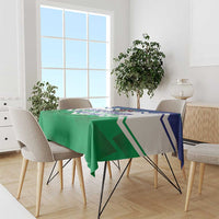 Green tablecloth with bold zigzag design and central printed text, on dining table