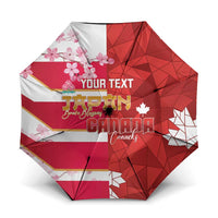 Red custom umbrella with Canada flag stripes and geometric maple leaf print