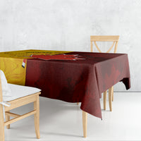 Rectangular soccer tablecloth draped over table, gold and dark red design