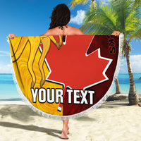 Round beach blanket with gold kangaroo and red Canada maple-leaf graphic, white fringe