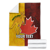Folded gold and dark red blanket showing kangaroo, maple leaf, and 'YOUR TEXT'