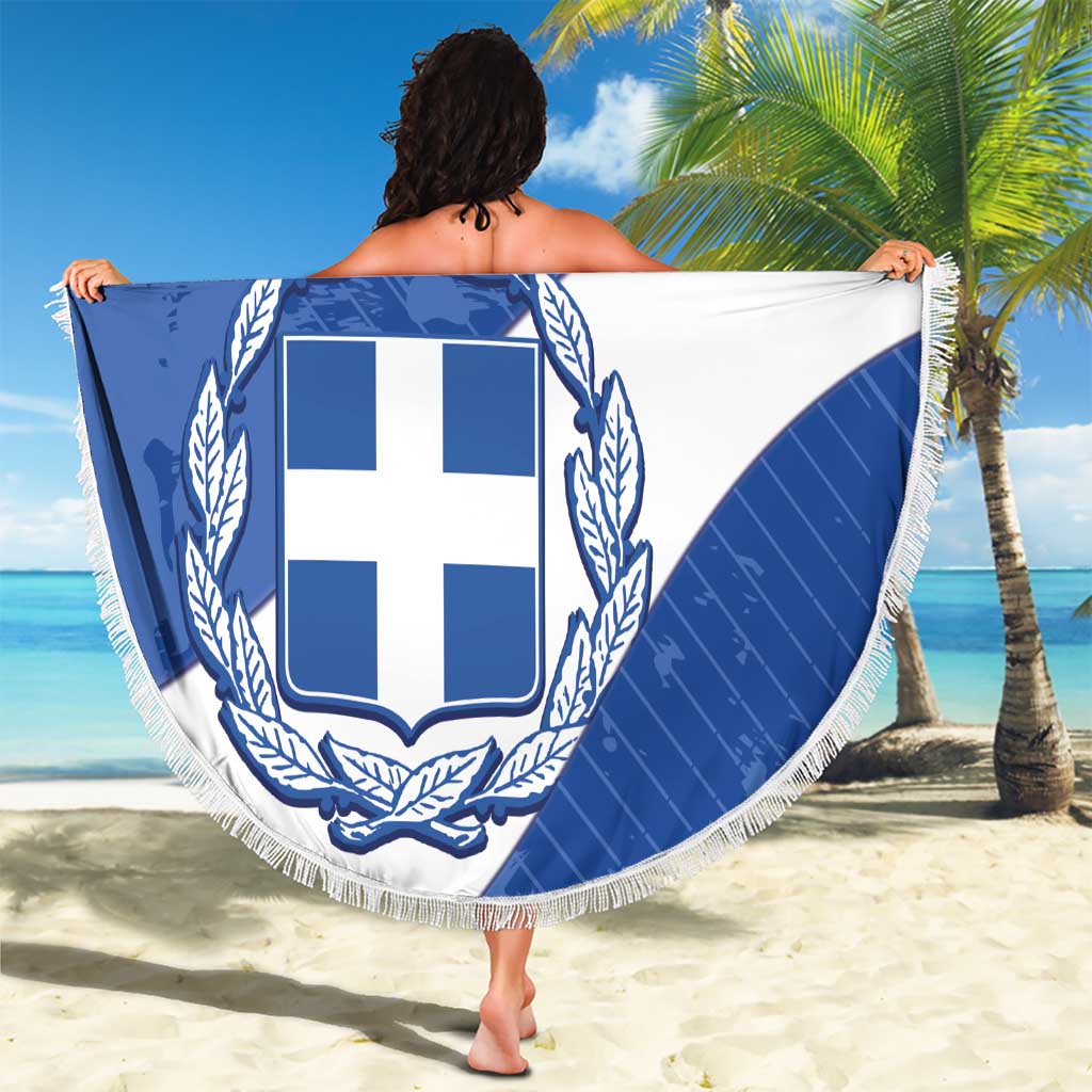 Round blue and white crest beach blanket with white fringe, held up by person