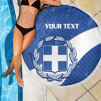 Round blue and white Greece crest beach blanket with white fringe, poolside